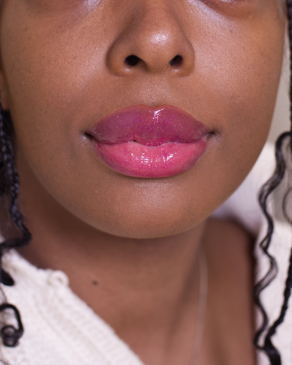 swatch of Fenty Beauty lip oil in the shade Raspberry Jamz