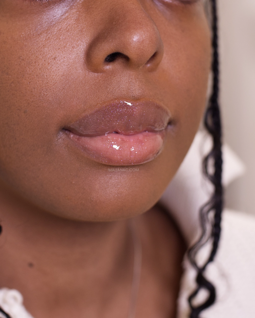 Fenty Beauty lip oil on dark skin in shade Rose Amber